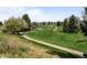 Picturesque community view showcasing lush green golf course and walking paths at 33 Canongate Ln, Highlands Ranch, CO 80130