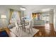 Charming dining room with a glass table and access to the kitchen, ideal for entertaining guests at 33 Canongate Ln, Highlands Ranch, CO 80130