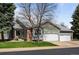 Well-maintained home featuring a three-car garage and manicured front lawn at 33 Canongate Ln, Highlands Ranch, CO 80130
