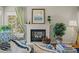 Bright and cozy fireplace with decor including a painting and indoor plants with a window view at 33 Canongate Ln, Highlands Ranch, CO 80130