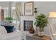 Bright and cozy fireplace with decor including a painting and indoor plants with a window view at 33 Canongate Ln, Highlands Ranch, CO 80130