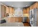 Bright kitchen featuring stainless steel appliances, light wood cabinets, and stone countertops at 33 Canongate Ln, Highlands Ranch, CO 80130