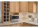 Close up of kitchen featuring a wine rack, microwave, and granite countertops at 33 Canongate Ln, Highlands Ranch, CO 80130