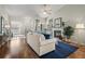 Bright living room featuring a ceiling fan, fireplace, hardwood floors, and comfortable seating at 33 Canongate Ln, Highlands Ranch, CO 80130