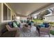 Relaxing covered patio features comfortable seating and an outdoor rug for added comfort at 33 Canongate Ln, Highlands Ranch, CO 80130