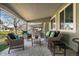 Inviting covered patio featuring wicker furniture, providing an ideal outdoor living space at 33 Canongate Ln, Highlands Ranch, CO 80130
