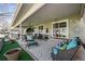 Inviting covered patio with a swing chair, comfortable seating, and a charming outdoor decor at 33 Canongate Ln, Highlands Ranch, CO 80130