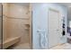 Tiled shower with a built-in seat and a glass door, blending style and functionality at 33 Canongate Ln, Highlands Ranch, CO 80130