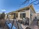 Backyard featuring a porch swing, brick pavers, and a well-maintained exterior at 20370 E 52Nd Ave, Denver, CO 80249