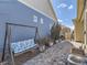 Backyard with a porch swing, stone landscaping, and an AC unit near the siding at 20370 E 52Nd Ave, Denver, CO 80249