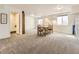 Spacious basement with neutral carpet, and a dining area with a modern light fixture and an adjacent bathroom at 20370 E 52Nd Ave, Denver, CO 80249