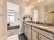 Bathroom features double sinks, granite countertops, and a view into the spacious main bedroom at 20370 E 52Nd Ave, Denver, CO 80249