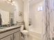 Well-lit bathroom showcasing a granite-topped vanity, mirror, toilet, and bathtub with white tiling at 20370 E 52Nd Ave, Denver, CO 80249