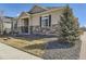 A well-kept lawn and rock garden complement the tan exterior of this inviting residence at 20370 E 52Nd Ave, Denver, CO 80249