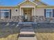 Inviting facade featuring stone accents, neutral siding, and a welcoming covered entrance at 20370 E 52Nd Ave, Denver, CO 80249