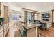 Gourmet kitchen with island seating, granite counters, and open layout to the living area at 20370 E 52Nd Ave, Denver, CO 80249