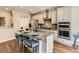 Well-appointed kitchen featuring a central island, stainless steel appliances, and sleek cabinetry at 20370 E 52Nd Ave, Denver, CO 80249