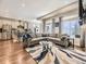 Spacious open-concept living area featuring hardwood floors and seamlessly flowing to the kitchen at 20370 E 52Nd Ave, Denver, CO 80249
