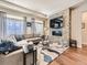 Stylish living room with tile fireplace, hardwood floors, and abundant natural light at 20370 E 52Nd Ave, Denver, CO 80249