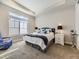 Comfortable main bedroom with tray ceiling and large window offering ample natural light at 20370 E 52Nd Ave, Denver, CO 80249