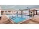 Indoor pool with clear blue water, overhead garage doors, and plenty of natural light at 20370 E 52Nd Ave, Denver, CO 80249