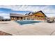 Exterior view of the pool and clubhouse with lounge chairs and a covered pool at 20370 E 52Nd Ave, Denver, CO 80249