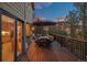 Spacious back deck with an umbrella-covered dining set, ideal for outdoor entertaining and dining at 7192 Pinewood Dr, Evergreen, CO 80439
