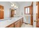 Bathroom with double sinks, vanity and a large mirror at 7192 Pinewood Dr, Evergreen, CO 80439