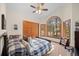 Bright bedroom featuring a vaulted ceiling, large arched window, and wood-trimmed closet at 7192 Pinewood Dr, Evergreen, CO 80439