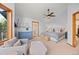 Primary bedroom boasts vaulted ceiling, ceiling fan, sitting area, and ensuite bathroom at 7192 Pinewood Dr, Evergreen, CO 80439