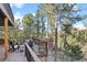 A spacious wrap-around deck offers panoramic views of the surrounding trees and mountains at 7192 Pinewood Dr, Evergreen, CO 80439
