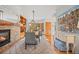 Elegant dining room featuring a fireplace, built-in shelving, and comfortable seating at 7192 Pinewood Dr, Evergreen, CO 80439