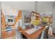 Stylish dining room with hardwood floors, modern lighting, and access to other living spaces at 7192 Pinewood Dr, Evergreen, CO 80439