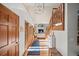 Inviting entryway featuring wood floors, a staircase, and a view into the living room at 7192 Pinewood Dr, Evergreen, CO 80439