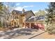 Exterior view of a two-story home with an attached three-car garage at 7192 Pinewood Dr, Evergreen, CO 80439