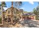 Exterior view of a home with a two-car garage, a deck, and a driveway at 7192 Pinewood Dr, Evergreen, CO 80439