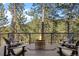 Inviting outdoor deck with a fire pit and scenic mountain views at 7192 Pinewood Dr, Evergreen, CO 80439