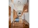 Welcoming foyer with hardwood floors, staircase, and plenty of natural light at 7192 Pinewood Dr, Evergreen, CO 80439