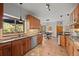 Spacious kitchen with wood cabinets, stainless appliances, and adjacent breakfast nook at 7192 Pinewood Dr, Evergreen, CO 80439