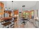 Open kitchen and breakfast area with wood cabinets, stainless steel appliances, and island seating at 7192 Pinewood Dr, Evergreen, CO 80439