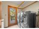 Laundry room with washer, dryer and access to a deck at 7192 Pinewood Dr, Evergreen, CO 80439