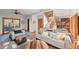 Open-concept living room featuring hardwood floors, a fireplace, and comfortable seating at 7192 Pinewood Dr, Evergreen, CO 80439