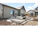 Back patio with chairs and fire pit, ideal for relaxation and outdoor gatherings at 8503 Estes Park Ave, Littleton, CO 80125