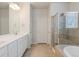 Spacious bathroom with double vanity, a large shower, and a separate bathtub at 8503 Estes Park Ave, Littleton, CO 80125