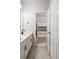 Bathroom with dual sinks that leads into bedroom with bunk beds at 8503 Estes Park Ave, Littleton, CO 80125