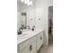 Bathroom with dual sinks that opens into bedroom with bunk beds at 8503 Estes Park Ave, Littleton, CO 80125