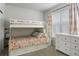 Bedroom with a bunk bed, dresser, and natural light at 8503 Estes Park Ave, Littleton, CO 80125