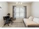 Bedroom with a daybed, desk and floral curtains for privacy at 8503 Estes Park Ave, Littleton, CO 80125