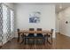 Bright dining room with a wooden table, stylish chairs, a bench and elegant window coverings at 8503 Estes Park Ave, Littleton, CO 80125