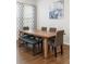 Dining room featuring a wooden table, gray upholstered chairs, bench and decorative window coverings at 8503 Estes Park Ave, Littleton, CO 80125